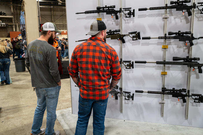 People look at guns and ammunition at the Great American Outdoor Show on Feb. 9 in Harrisburg, Penn. Former President Donald Trump spoke at the event.