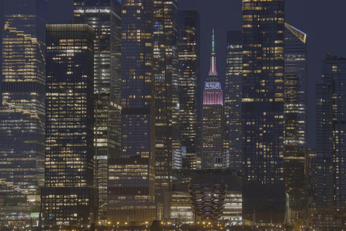 The Empire State Building is lit in pastel colors to mark Easter as it stands between the towers of Hudson Yards in New York City on March 31.