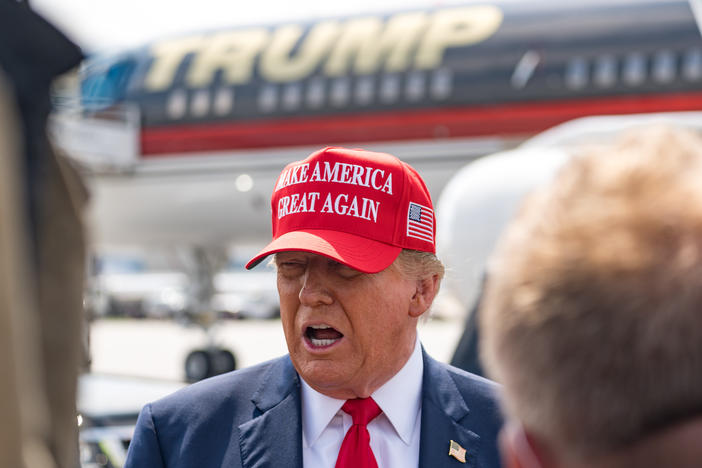 Former President Donald Trump speaks to the media as he arrives at the airport on Wednesday in Atlanta, Georgia. Trump is visiting Atlanta for a campaign fundraising event he is hosting.