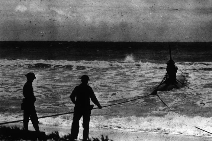 An American hauls in a HA-19 Japanese submarine following the attack on Pearl Harbor in 1941. Submarine warfare would prove crucial during WWII.