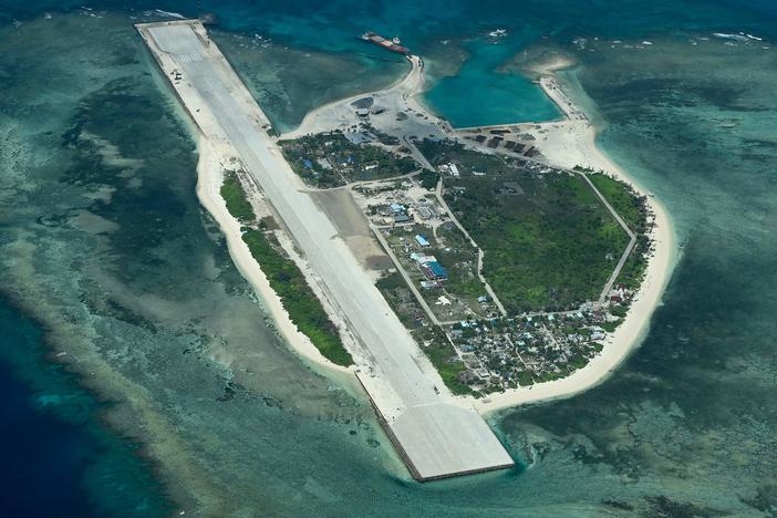 An aerial view taken on March 9, 2023 shows Thitu Island in the South China Sea. - As a Philippine Coast Guard plane carrying journalists flew over the Spratly Islands in the hotly disputed South China Sea, a Chinese voice issued a stern command over the radio: "Leave immediately."