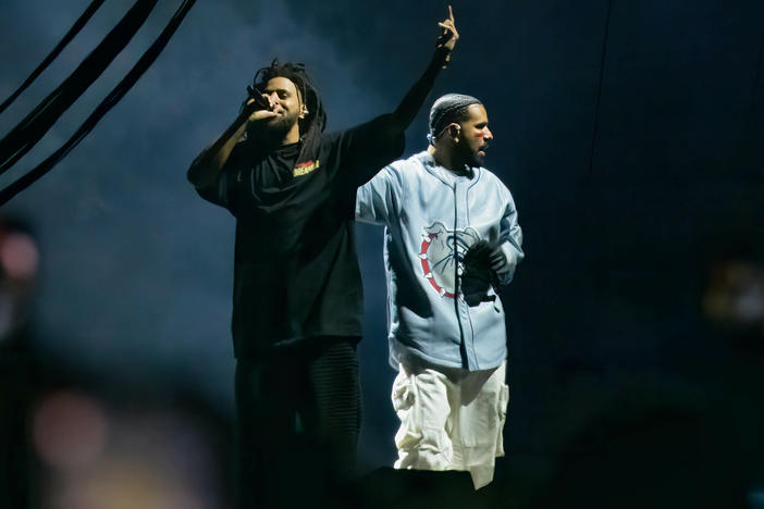 J. Cole and Drake perform during the 2023 edition of Cole's Dreamville festival in Raleigh, N.C., last April. Their collaborative track "First Person Shooter" recently touched off a war of words with fellow MC Kendrick Lamar.