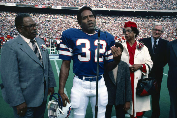 O.J. Simpson, accompanied by his parents, his son, Jason, and Ralph Wilson, owner of the Buffalo Bills, is inducted into the Wall of Fame in Rich Stadium on Sept. 14, 1980.