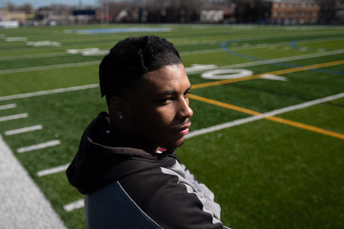 Kahlil Brown, 18, says teammate Deshaun Hill Jr., the student and quarterback who was shot and killed in 2022, was his best friend. Brown, shown posing for a portrait at the North Community High School football field in Minneapolis on April 9, will attend St. Olaf College in the fall.