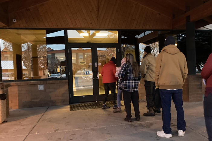 People line up outside a public assistance office in Missoula, Montana, before its doors open at 8 a.m., Oct. 27, 2023, to try to regain health coverage after being dropped from Medicaid, a government insurance program for people with low incomes and disabilities.