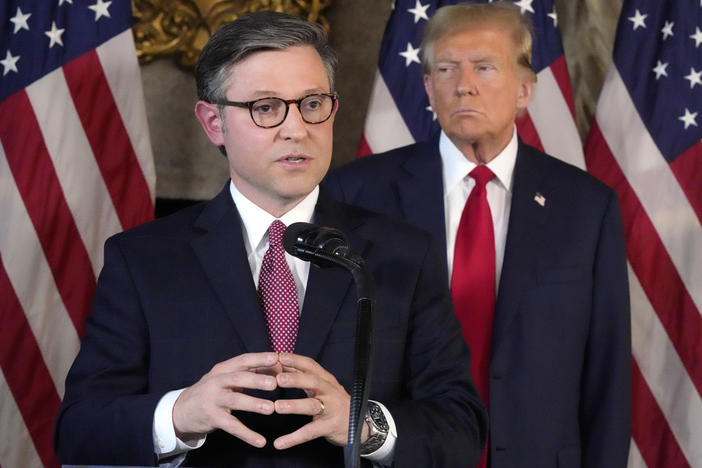 House Speaker Mike Johnson, R-La., speaks as former President Donald Trump listens during a news conference Friday at Trump's Mar-a-Lago resort in Palm Beach, Fla.