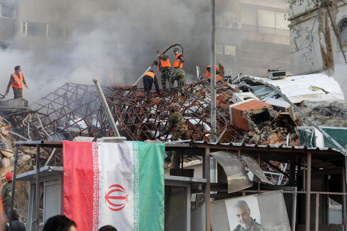 Emergency and security personnel extinguish a fire at the site of strikes that hit a building annexed to the Iranian embassy in Syria's capital Damascus on April 1. Iran blames Israel for the attack.