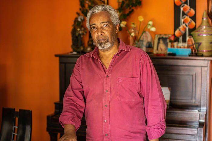 Albert Rudatsimburwa, a freelancer journalist reporting in the East African region poses for a portrait in his home.