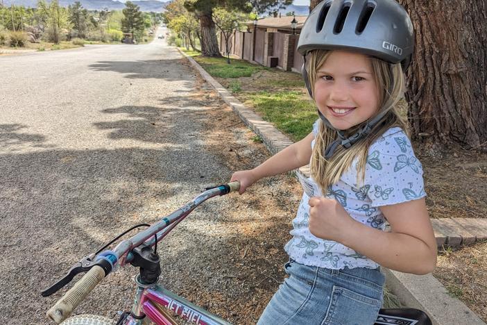 The author's 8-year-old daughter, Rosy, has a "kids' license," showing she has her parents' permission to ride her bike around her Texas hometown.