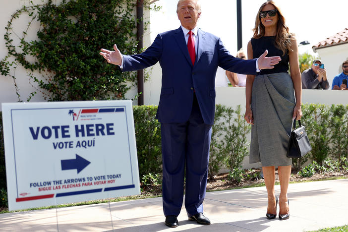 Former President Donald Trump stands with former first lady Melania Trump after voting in 2022.