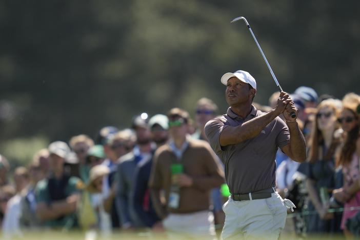 Tiger Woods watches his chip on the 18th hole Friday at the Masters tournament at Augusta National Golf Club in Augusta, Ga.