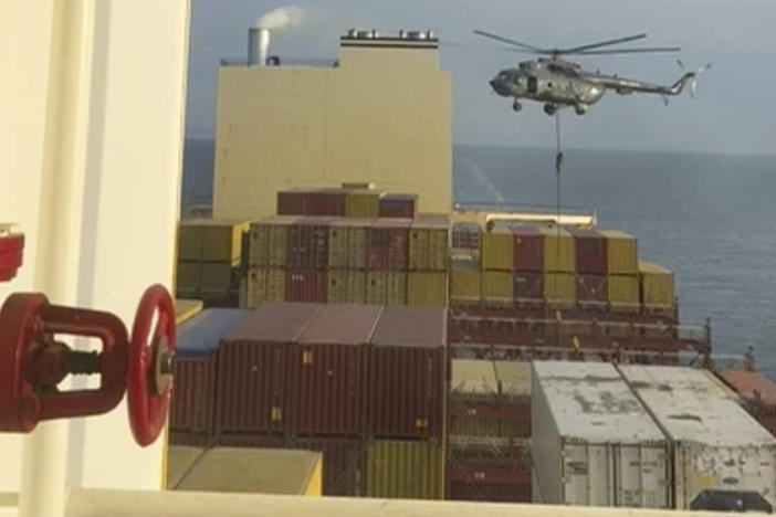 This image made from a video provided to The Associated Press by a Mideast defense official shows a helicopter raid targeting a vessel near the Strait of Hormuz on Saturday.