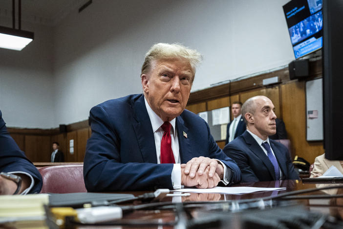 Former President Donald Trump appears with his legal team ahead of the start of jury selection Monday at Manhattan criminal court. Trump faces 34 felony counts of falsifying business records in the first of his criminal cases to go to trial.