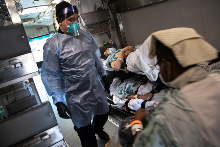 An EMT wearing personal protective equipment prepares to unload COVID-19 transfer patients in the early days of the pandemic. The Biden Administration has just announced a new program aimed at preventing the next pandemic.