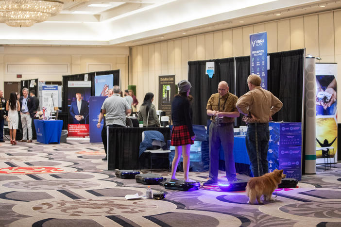 Attendees visit booths at the RePlatform conference in Las Vegas in March. The conference crowd was a hybrid of anti-vaccine activists, supporters of former President Donald Trump and Christian conservatives.