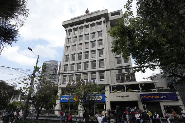 People stand outside the Venezuelan embassy in Quito, Ecuador, on Tuesday.