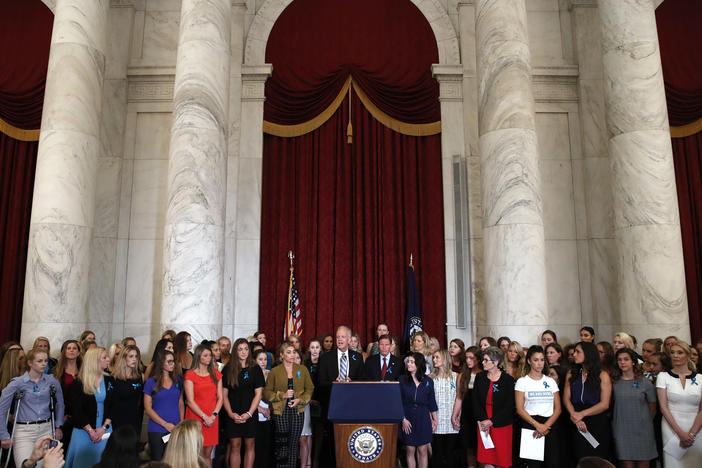 Sen. Jerry Moran, R-Kansas, center left, and Sen. Richard Blumenthal, D-Conn., attend a news conference with dozens of women and girls who were sexually abused by Larry Nassar, a former doctor for Michigan State University athletics and USA Gymnastics, July 24, 2018, on Capitol Hill in Washington.
