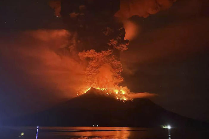 In this photo released by Sitaro Regional Disaster Management Agency (BPBD Sitaro), hot molten lava glows at the crater of Mount Ruang as it erupts in Sanguine Islands, Indonesia, Wednesday, April 17, 2024.