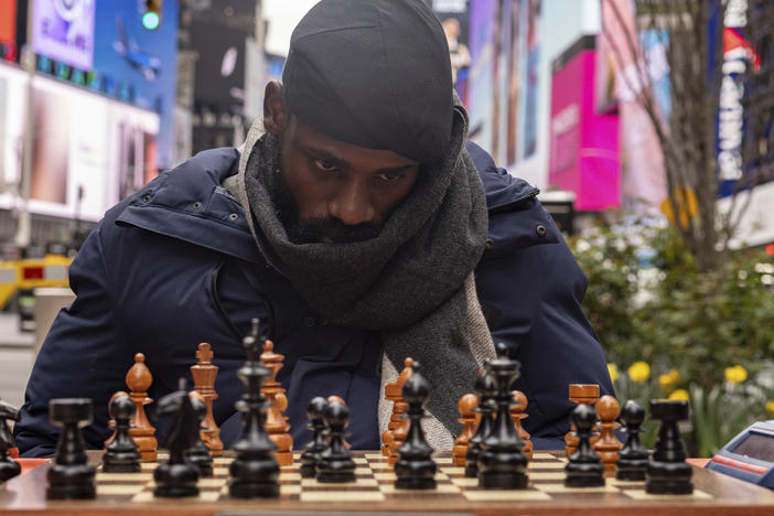 Tunde Onakoya, a Nigerian chess champion and child education advocate, plays a chess game in Times Square, Friday, April 19, 2024, in New York