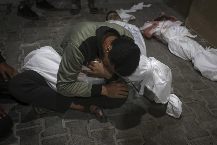 A Palestinian youth mourns his relative killed in the Israeli bombardment of the Gaza Strip, at the morgue of the Kuwaiti Hospital in Rafah refugee camp, southern Gaza Strip, early Saturday, April 20, 2024.