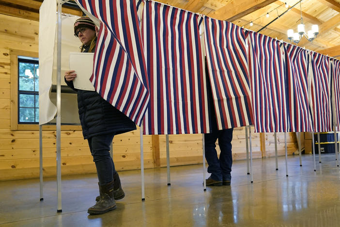 A voter leaves a voting booth in Concord, N.H., the during primary election on Jan. 23, 2024.