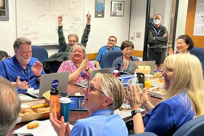 Members of the Voyager team celebrate at NASA's Jet Propulsion Laboratory after receiving data about the health and status of Voyager 1 for the first time in months.
