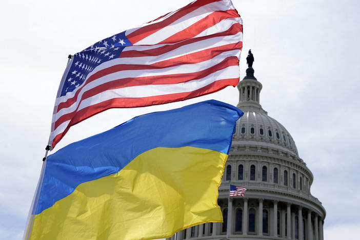 The American and Ukrainian flags wave in the wind outside of the Capitol. The Senate is moving ahead with $95 billion in war aid to Ukraine, Israel and Taiwan.