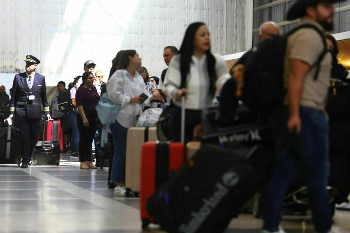 Travelers and their luggage in a terminal at Los Angeles International Airport in August 2023.