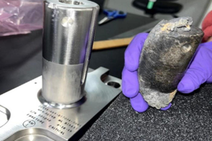 NASA says this stanchion, at right, had been expected to burn up during reentry, but instead it struck a man's house in Florida. The object is seen here next to another stanchion in pristine shape, at left.