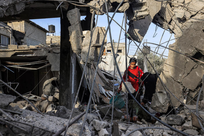 Amid the rubble of a collapsed building in Rafah, in southern Gaza, a woman and a girl search for items on April 24, following reported Israeli airstrikes overnight.