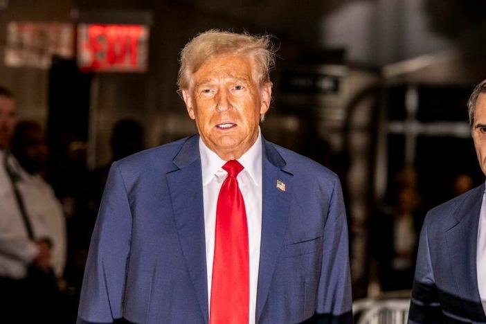Former President Trump talks to reporters after his hush-money trial in New York adjourned for the day Thursday.