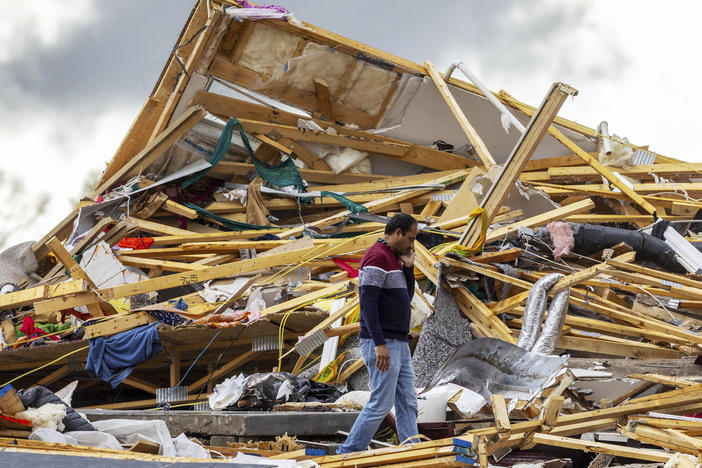 Gopala Penmetsa walks past his house after it was leveled by a tornado near Omaha, Neb., on Friday.