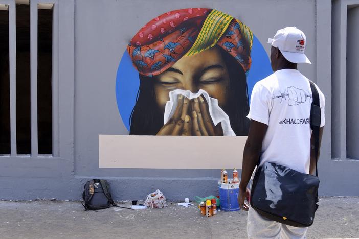 Don't just sneeze without a tissue! That's the message of this early pandemic era graffiti in Dakar, Senegal. The World Health Organization has just issued an updated report on the way SARS-CoV-2 spreads. Take our quiz to see if you're up on your COVID terminology.