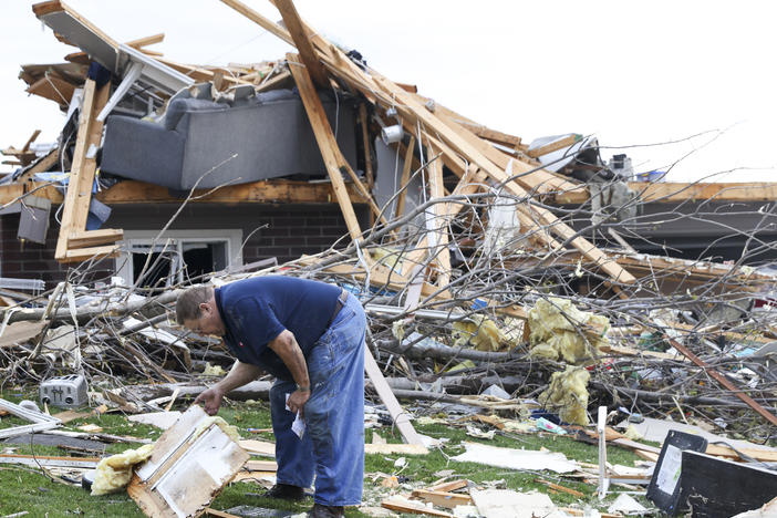 Terry Kicking sifts through the damage after a tornado leveled his home on Friday in Omaha, Neb.