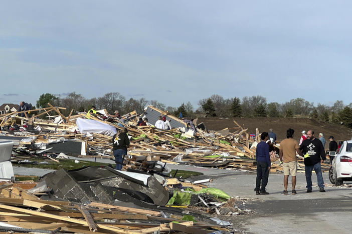 People pick through the rubble of a house that was leveled in Elkhorn, Neb., on Saturday. At least four people were killed by tornadoes.