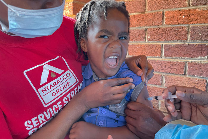 A child receives a measles vaccination at a clinic in Harare, Zimbabwe, where a 2022 outbreak saw some 700 children die from the highly infectious childhood disease.