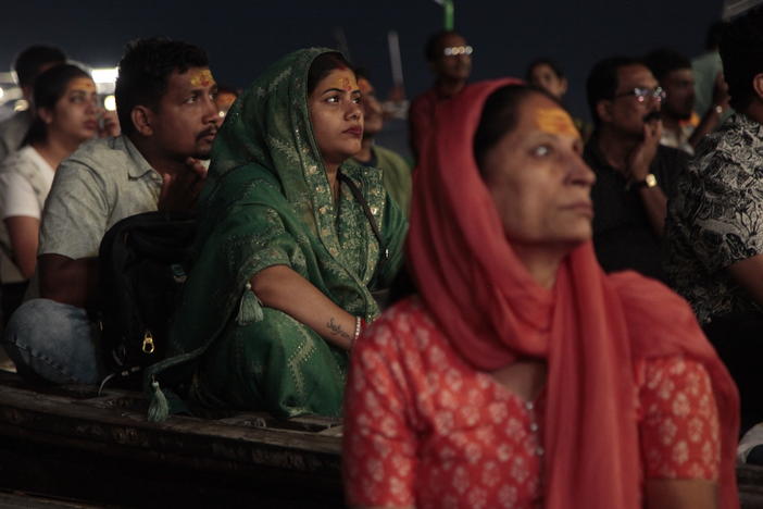 Worshippers and tourists sit on boats facing the bank of the Ganges River in the holy Hindu city of Varanasi to watch the Ganga Aarti, a ritual of devotion to the venerated river. Hindu priests wave fire as the sun sets, ring bells and tap on drums. Thousands watch, clap and chant along from boats crammed in the water.