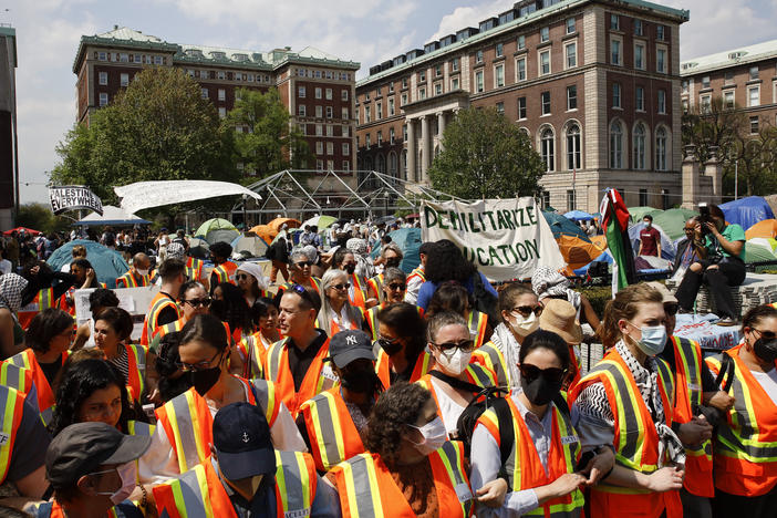 Columbia University faculty and staff gather on the campus in solidarity with student protesters on Monday.