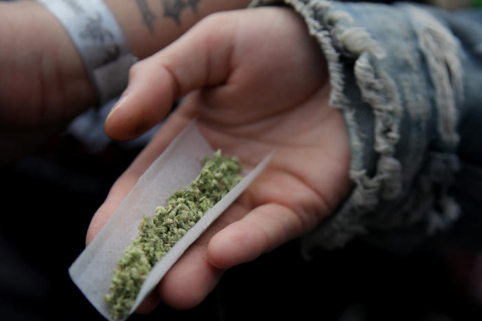 A person prepares a marijuana cigarette in New York City on April 20, 2024.