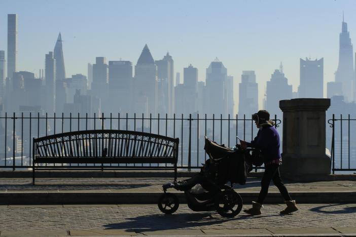 Amazon and Target are among the latest big retailers to stop selling weighted infant sleepwear due to concerns about safety. Here, a woman pushes a stroller as the New York skyline is seen from Weehawken, New Jersey.