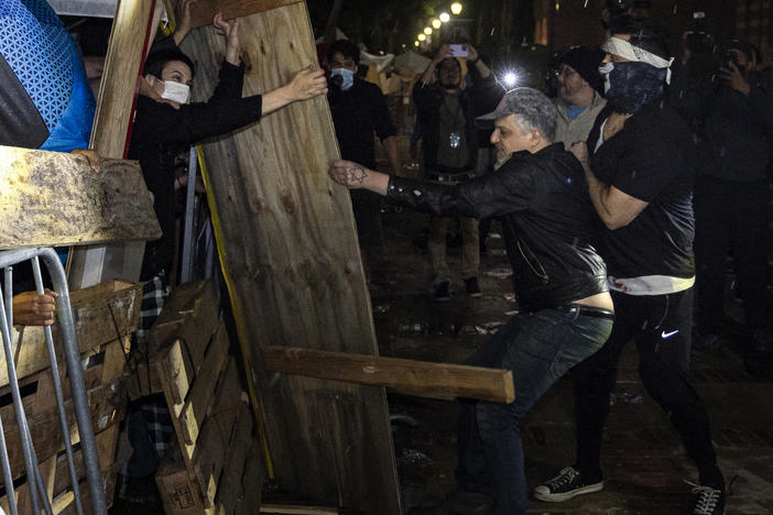 Counterprotesters try to dismantle a pro-Palestinian encampment set up on the University of California, Los Angeles campus in the early hours of Wednesday.