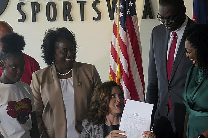 A number of Democratic lawmakers have reintroduced the CROWN Act, legislation that would ban discrimination based on one's hairstyle or hair texture. Here, Michigan Gov. Gretchen Whitmer signs Crown Act legislation on June 15, 2023 in Lansing, Mich. that will outlaw race-based hairstyle discrimination in workplaces and schools.