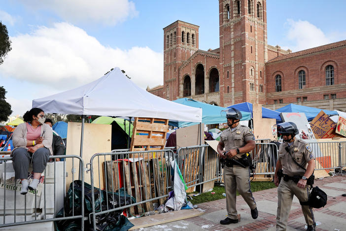 CA Highway Patrol officers walk on the University of California, Los Angeles campus on May 1, 2024 near a pro-Palestinian encampment. Hundreds of protesters have since been arrested on UCLA's campus.