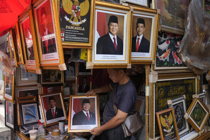 A vendor holds a portrait of Indonesian President-elect Prabowo Subianto at a market in Jakarta, Indonesia, April 24.
