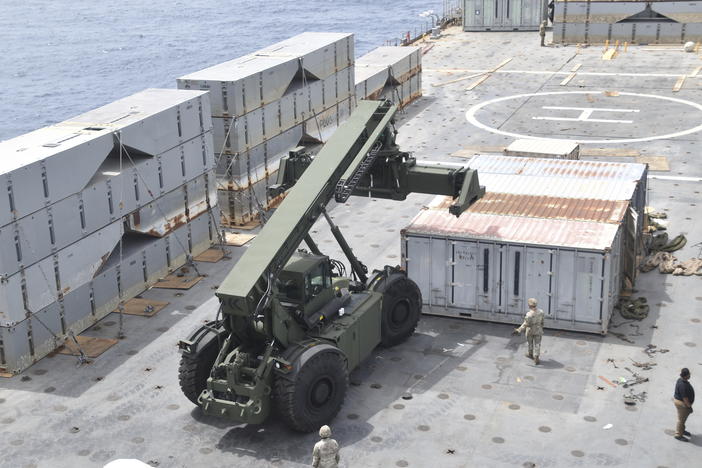 Soldiers assigned to the 7th Transportation Brigade and sailors attached to the MV Roy P. Benavidez assemble a floating pier off the shore of Gaza on April 26, 2024. The U.S. expects to have on-the-ground arrangements in Gaza ready for humanitarian workers to start delivering aid this month via a new U.S.-backed sea route.