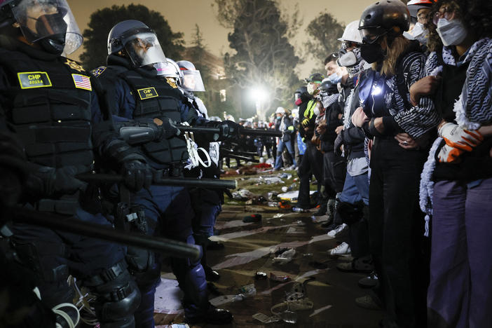 Police face off with pro-Palestinian students after dismantling part of the encampment barricade on the campus of the University of California, Los Angeles, early on May 2.