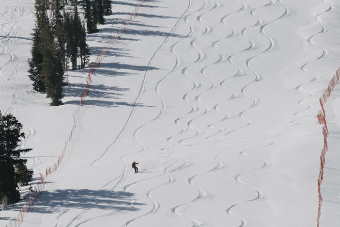 In this photo provided by Mammoth Mountain Ski Area, a snowboarder rides in Mammoth Lakes, Calif., Sunday, May 5, 2024.