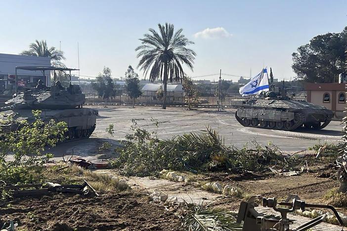 This photo provided by the Israel Defense Forces shows a tank with an Israel flag on it entering the Gazan side of the Rafah border crossing on Tuesday.