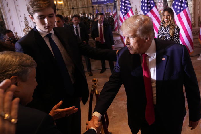 Former President Donald Trump greets people after announcing he is running for president for the third time as he speaks at Mar-a-Lago in Palm Beach, Fla., in 2022 as his son, Barron Trump, watches.