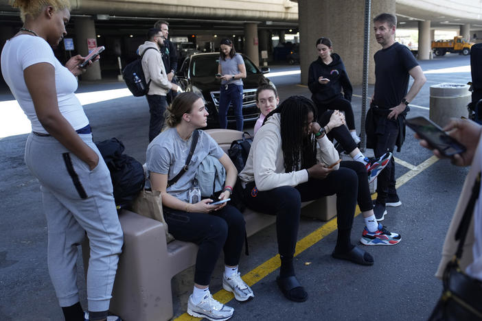 Players and staff of the New York Liberty WNBA basketball team wait to board buses at Harry Reid International Airport, Wednesday, June 28, 2023, in Las Vegas.